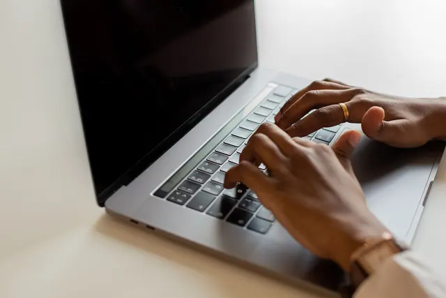 Hands typing on a laptop keyboard during a work session, showcasing modern connectivity. B2B SEO lead generation: the metrics that matter to sales, not just visits