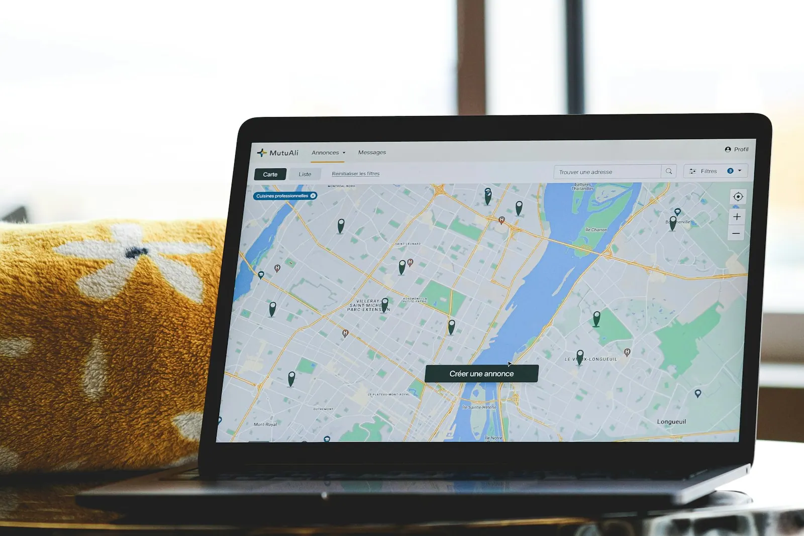 a laptop with a map on the screen. Canadian local SEO: managing bilingual listings and provincial citations