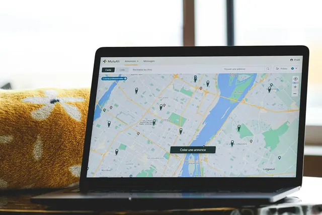 a laptop with a map on the screen. Canadian local SEO: managing bilingual listings and provincial citations