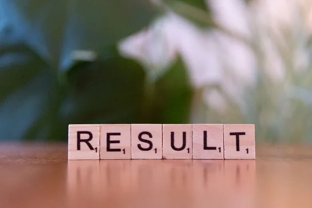 Wooden scrabble tiles arranged to spell RESULT on a wooden table. What matters most in on-page SEO mistakes