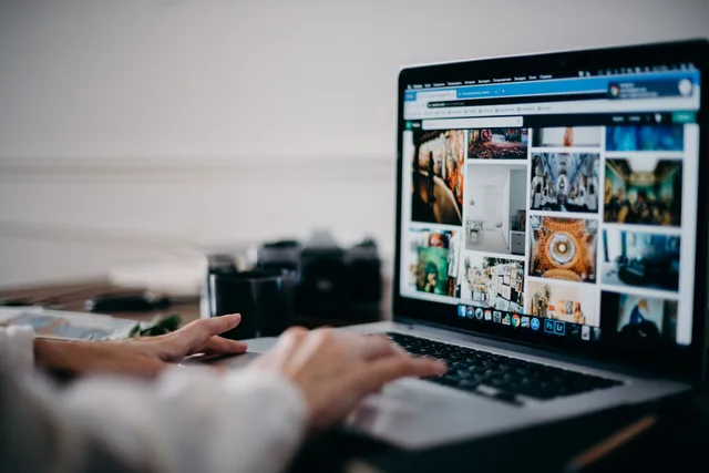 Close-up of hands using laptop for image searching and browsing digital photo gallery. Wix, Saramin, and Vimeo: what their SEO strategy changes actually proved
