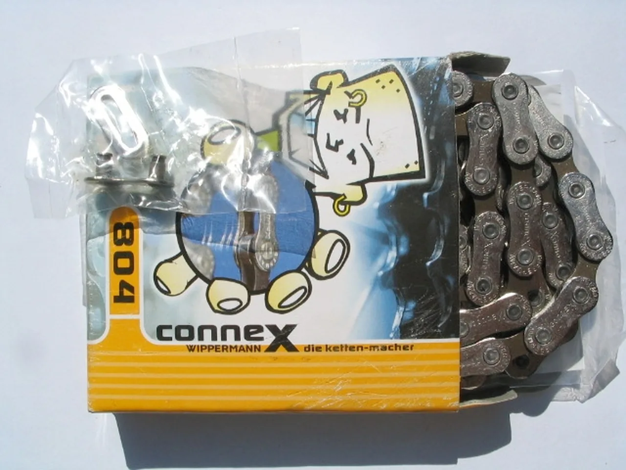 A close view of a metal bicycle chain and its connecting link.